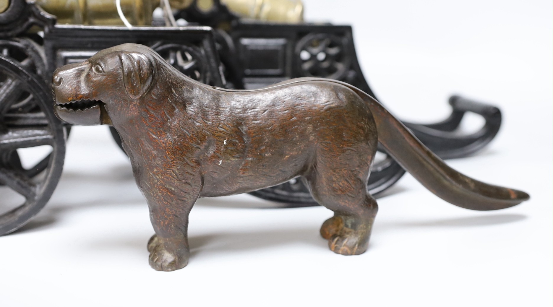 A pair of cast iron and bronze model cannons and a cast iron ‘dog’ nut cracker, cannons 42.5cm long